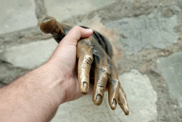 paris france  september  30  2006   -  hand shakes a hand with the statue to the writer Marcel Aime