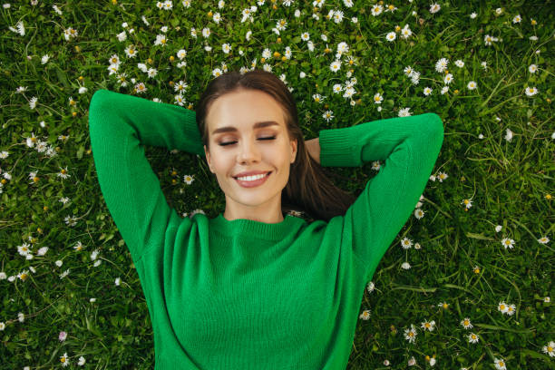 istock Beautiful woman lying on the grass 1333957505