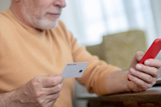 istock A man holding a smartphone and a credit card in hand 1333957741