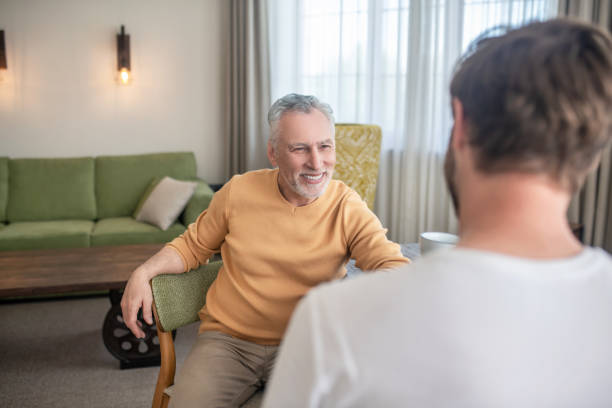 istock Two men sitting at the table, having tea and talking 1333958402