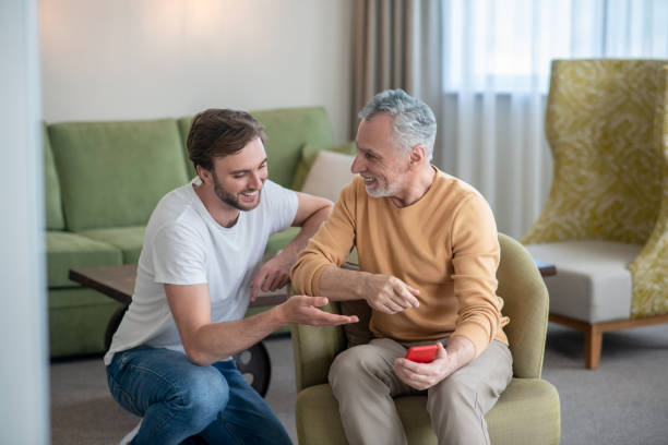 istock Young man explaining his dad how to use a new smartphone 1333958454