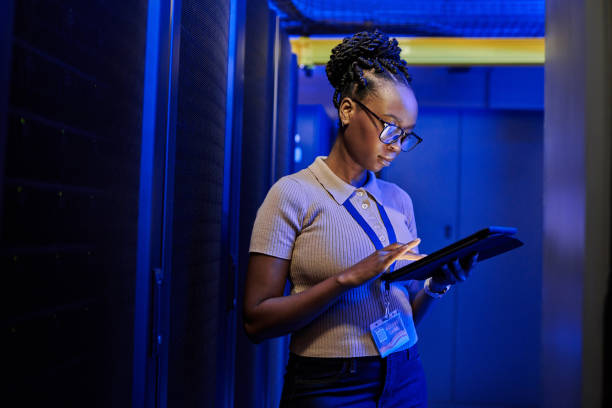 istock Shot of a young female engineer using a digital tablet while working in a server room 1333959184