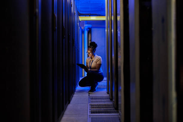 istock Shot of a young female engineer using a digital tablet while working in a server room 1333959196