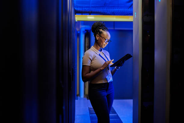 istock Shot of a young female engineer using a digital tablet while working in a server room 1333959199