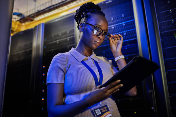 istock Shot of a young female engineer using a digital tablet while working in a server room 1333959204