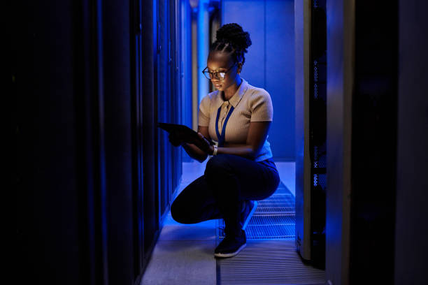 istock Shot of a young female engineer using a digital tablet while working in a server room 1333959209