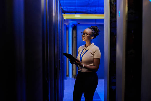 istock Shot of a young female engineer using a digital tablet while working in a server room 1333959222