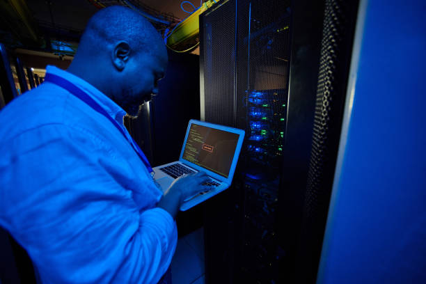 istock Shot of a male engineer using a laptop while working in a server room 1333959733