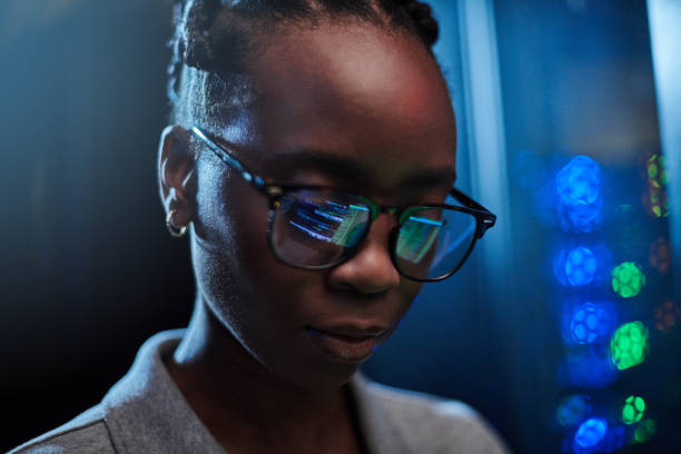 istock Shot of a young female engineer working in a server room 1333959746