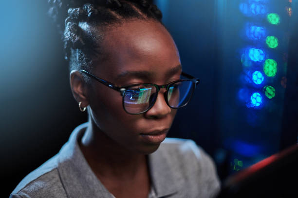 istock Shot of a young female engineer working in a server room 1333959749