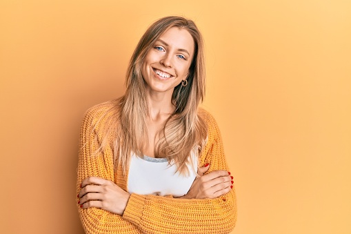 Beautiful caucasian woman wearing casual clothes happy face smiling with crossed arms looking at the camera. positive person.