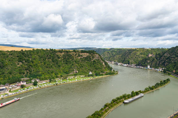 istock The river Rhine in western Germany flows between the hills covered with forest, visible barge and rock cliff. 1333967601