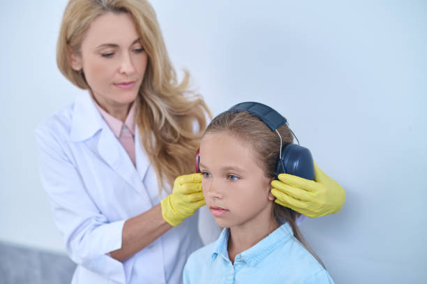 istock Focused audiologist preparing a young patient for an audiometry test 1333968153