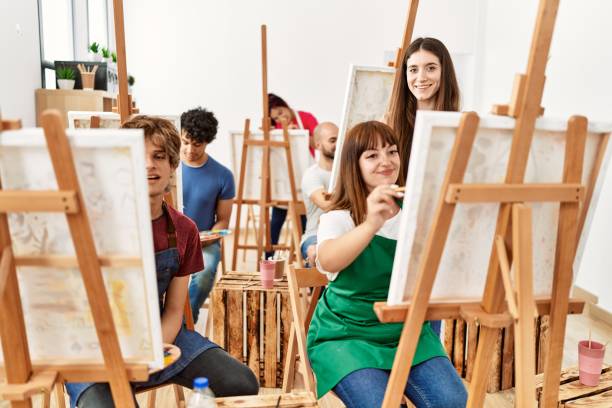 istock Group of young draw students smiling happy drawing at art studio. 1333968161