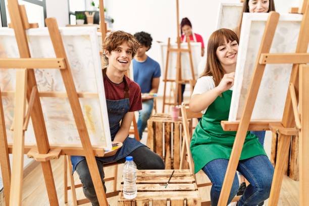 istock Group of young draw students smiling happy drawing at art studio. 1333968165