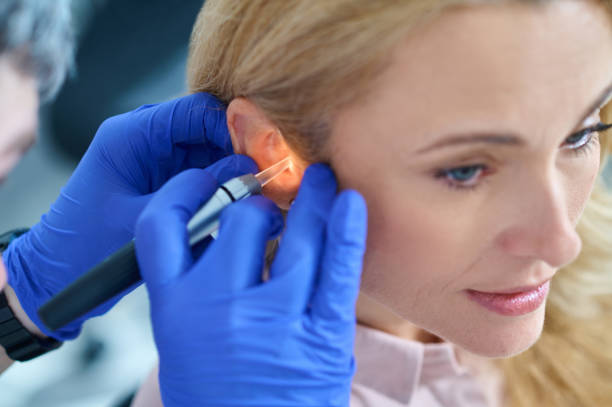 istock Hands in gloves with luminous device near womans ear 1333968919