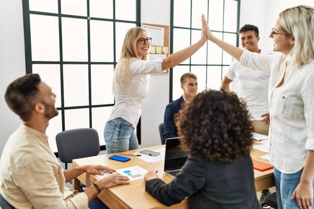 istock Two workers smiling happy high five during meeting at the office. 1333970463