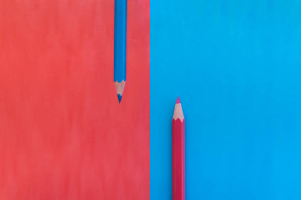 Divided pink and blue background with two matching colored pencils