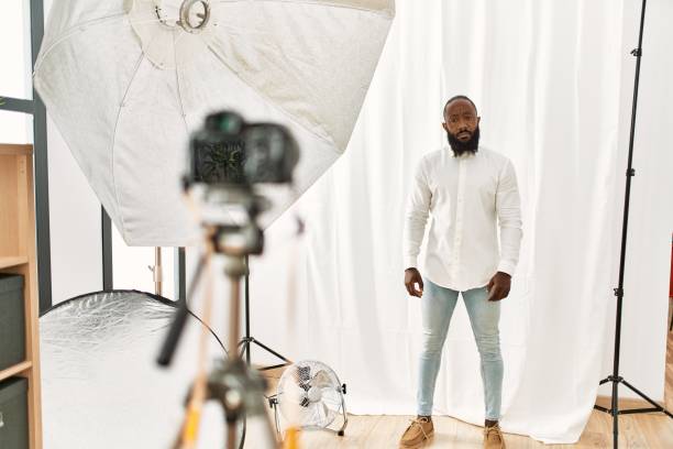 istock African american man posing as model at photography studio with serious expression on face. simple and natural looking at the camera. 1333972120