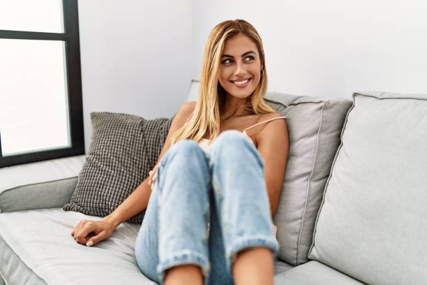 istock Young caucasian girl smiling happy sitting on the sofa at home. 1333972722