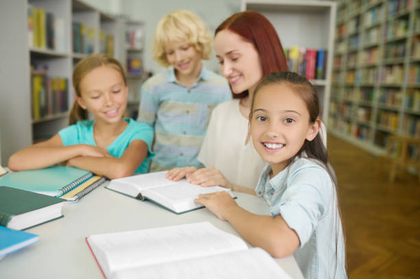 istock Cheerful pupil posing for the camera during a reading lesson 1333972832