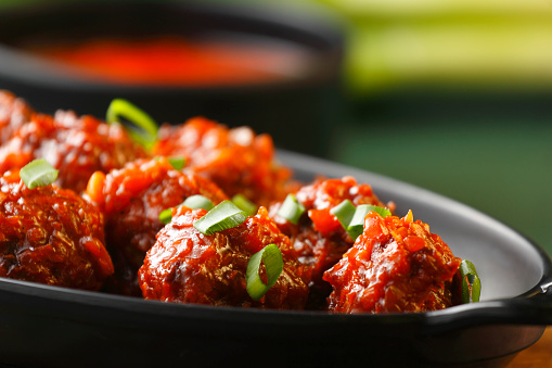 Cabbage Manchurian Served In Bowl On Table