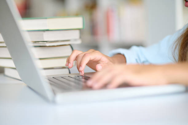 istock Young girls hands typing on the laptop 1333972977