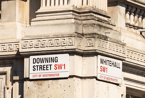 London, UK - A close-up of street signs at the corner between Whitehall and Downing Street in the City of Westminster, central London.