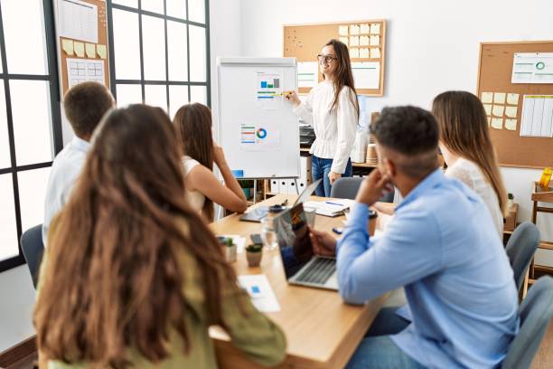 istock Group of business workers on chart board presentation at the office. 1333975729