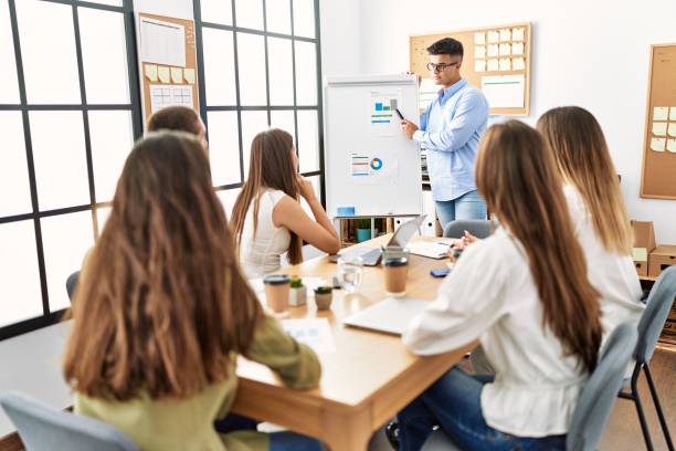 istock Group of business workers on chart board presentation at the office. 1333975730