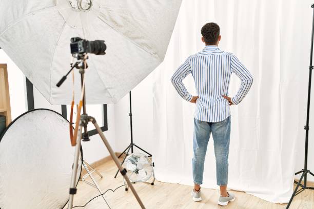 istock Arab young man posing as model at photography studio standing backwards looking away with arms on body 1333979591
