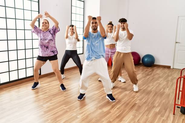 istock Group of young dancer smiling happy dancing choreography at dance academy. 1333980410