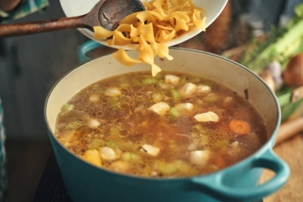 istock Preparing Chicken Noodles Soup with Fresh Vegetables 1333981860