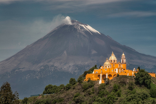 Evening view of a church with a volcano behind in Cholula, Puebla, Mexico