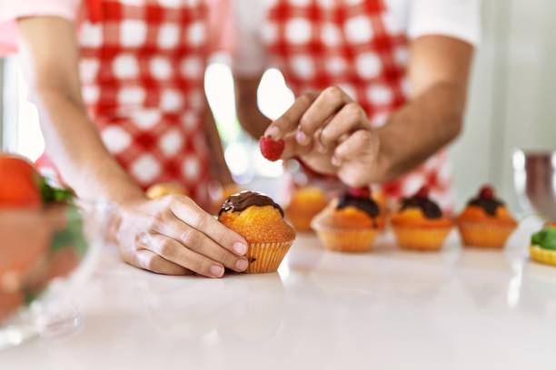 istock Hands of couple cooking pumpkins at kitchen. 1333982125