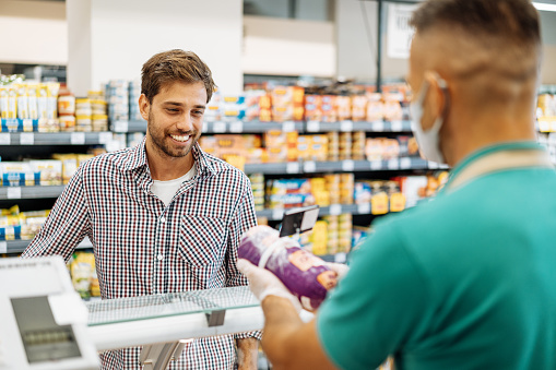 Employee In Supermarket Serving The Customer Stock Photo - Download ...