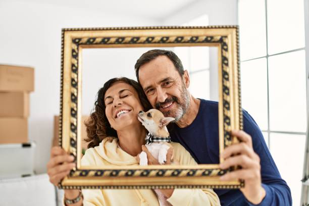 istock Middle age hispanic family smiling happy holding empty frame at new home. 1333984420