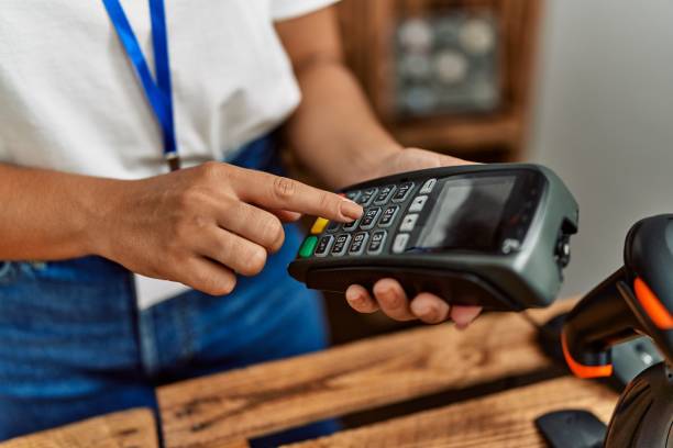 istock Shopkeeper woman using data phone at clothing store. 1333987528