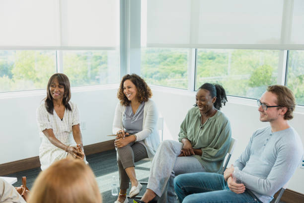istock Sitting in circle, focus group listens to unseen person 1333989494