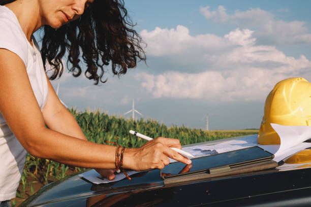 istock Female scientist working in the field, inspecting wind turbine efficiency 1333989890