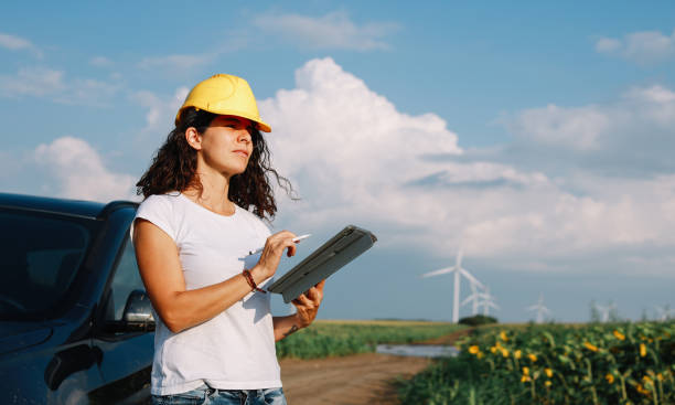istock Female scientist working in the field, inspecting wind turbine efficiency 1333989944
