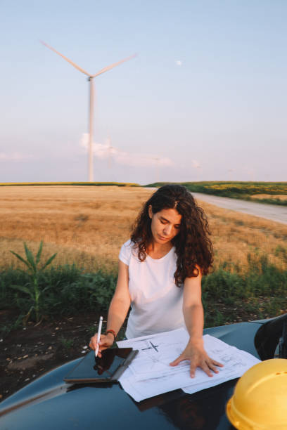 istock Female scientist working in the field, inspecting wind turbine efficiency 1333989968