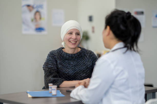 istock Smiling cancer patient at a medical check up 1333990004
