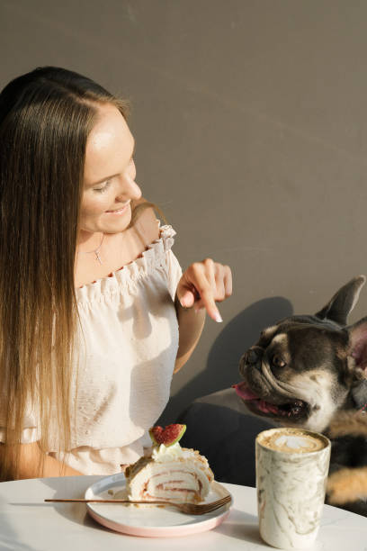 istock Russian girl communicates with her dog at a table in a cafe 1333992524