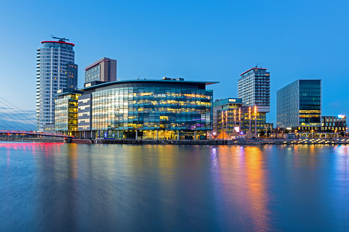 MediaCity UK at Salford Quays. MediaCityUK is a property development on the banks of the Manchester Ship Canal in Salford and Trafford, it is home to the BBC and many programs are produced there.