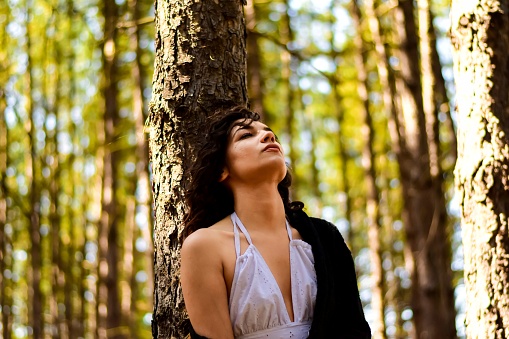 Stock photography of a young woman in the forest, seeking her self and knowlagde and letting her spirit roam free. Refreshing her mind and body, filling up with positive energy