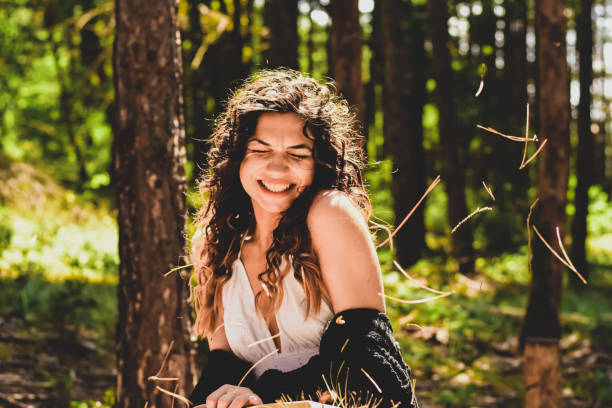 Stock photography of a young woman in the forest, seeking her self and knowlagde and letting her spirit roam free stock photo