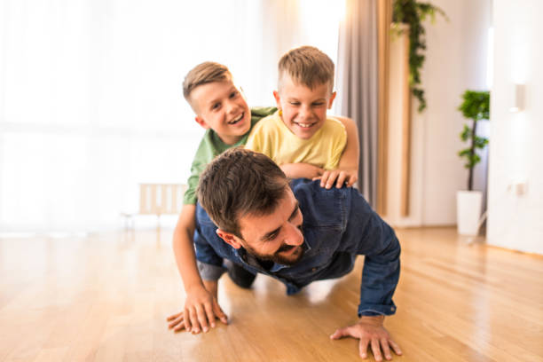 istock Happy father and his two boys having fun at home. 1333995768