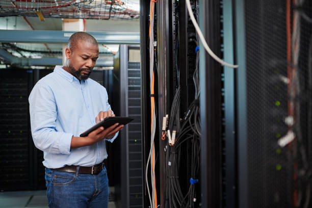 istock Shot of a mature man using a digital tablet in a server room 1334003828