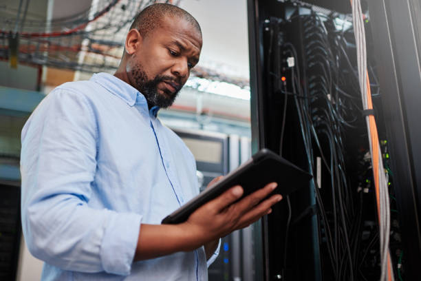 istock Shot of a mature man using a digital tablet in a server room 1334003872